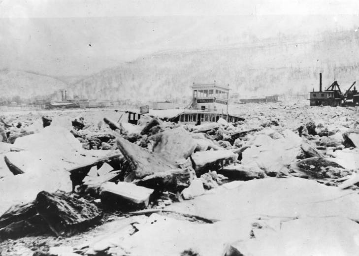 black and white photo of boat in ice